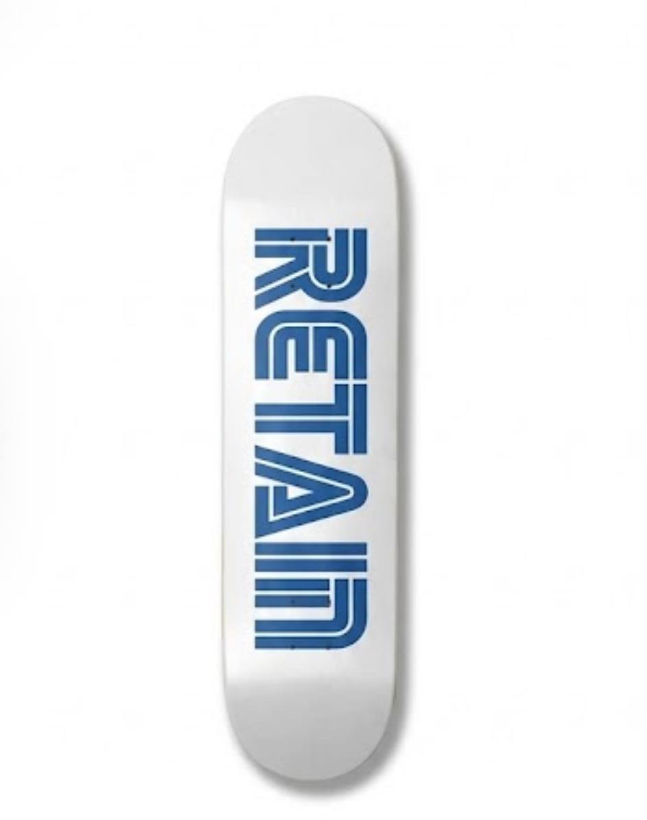 White skateboard deck bearing a geometrical blue RETAIN wordmark