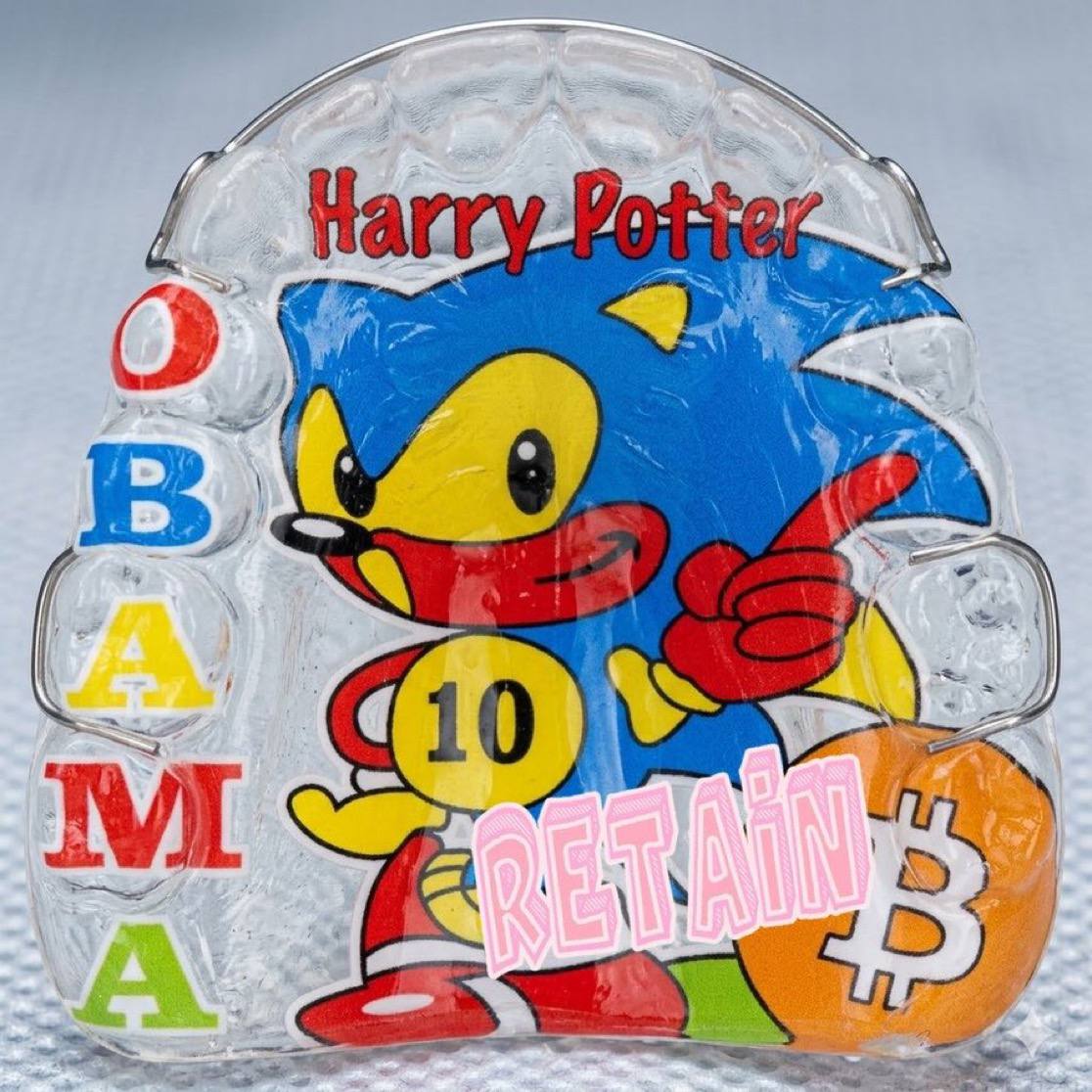 A translucent carved HPOS10I-style blue figure with RETAIN writing